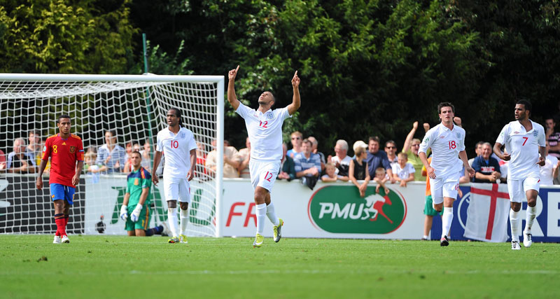 John Bostock celebrates scoring against Spain.